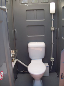 Luxury Sewer Connected Porta loo. Set up by Sydney Bathroom Hire, notice the pump behind the toilet.